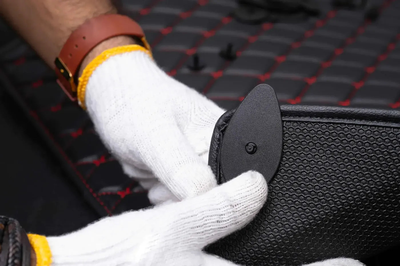 Built-in retention clip on the anti-slip mesh backing of a Luxus mat
