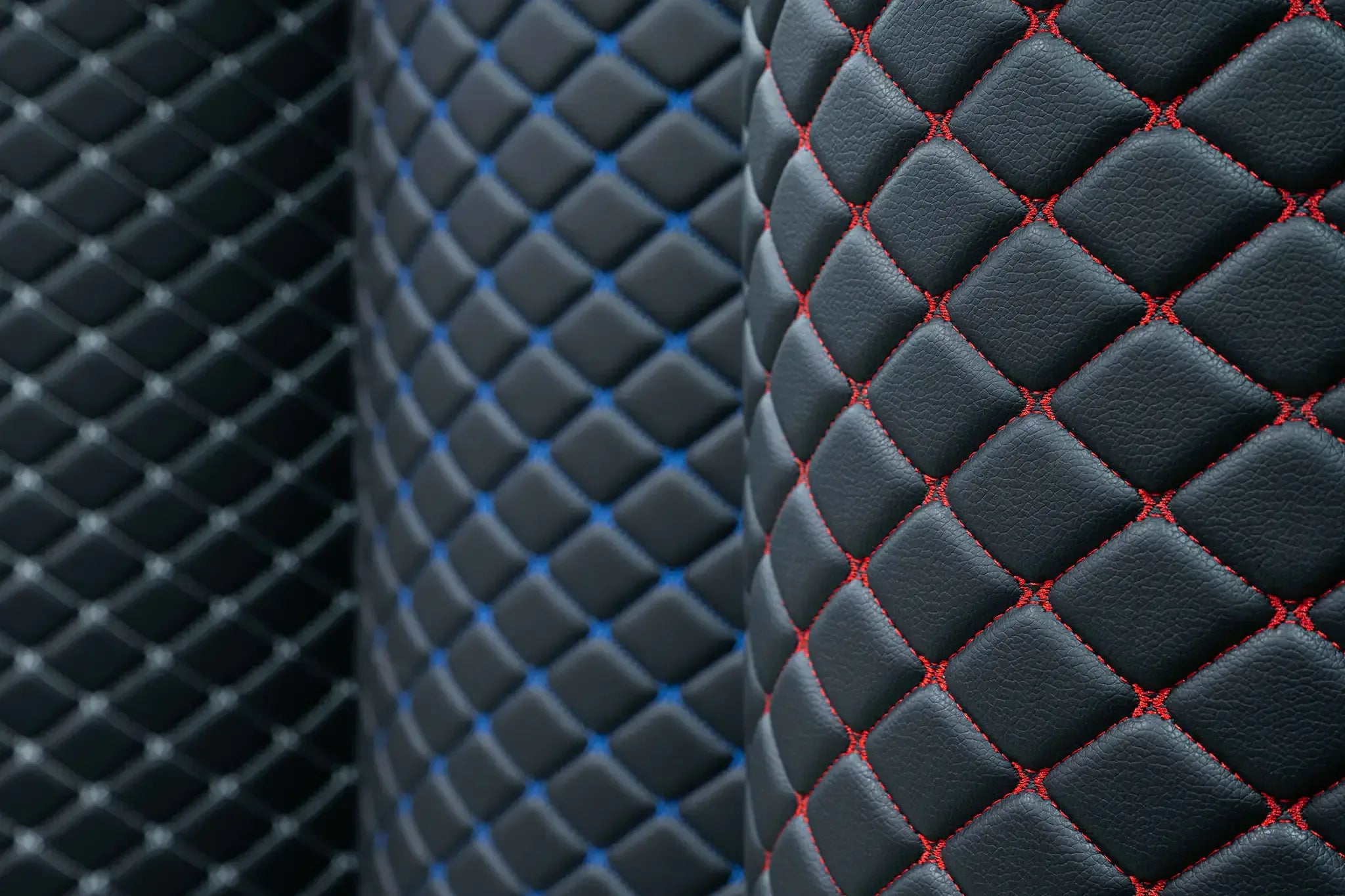 Rolls of Omnicore 14 eco-leather with diamond quilting in white, blue and red stitching