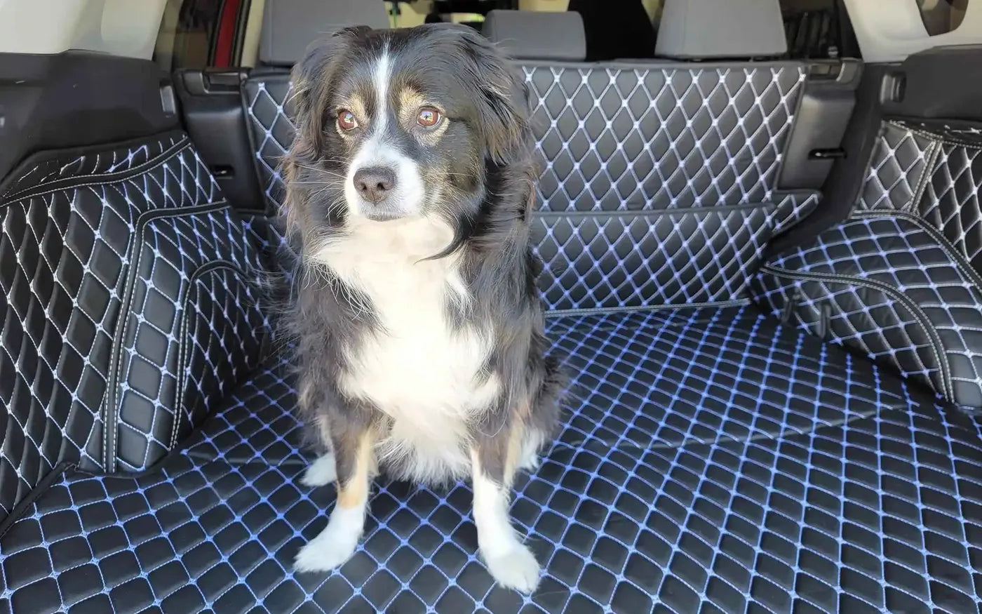 Dog sitting on a Luxus 360Fit trunk mat with diamond stitching