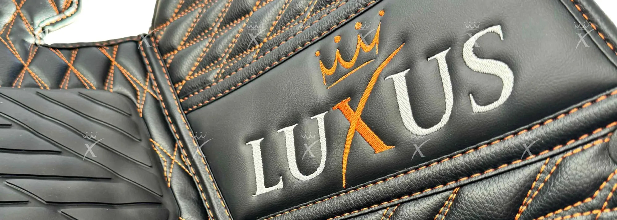 Luxus crown and wordmark embroidered on a black eco leather car mat with orange stitching