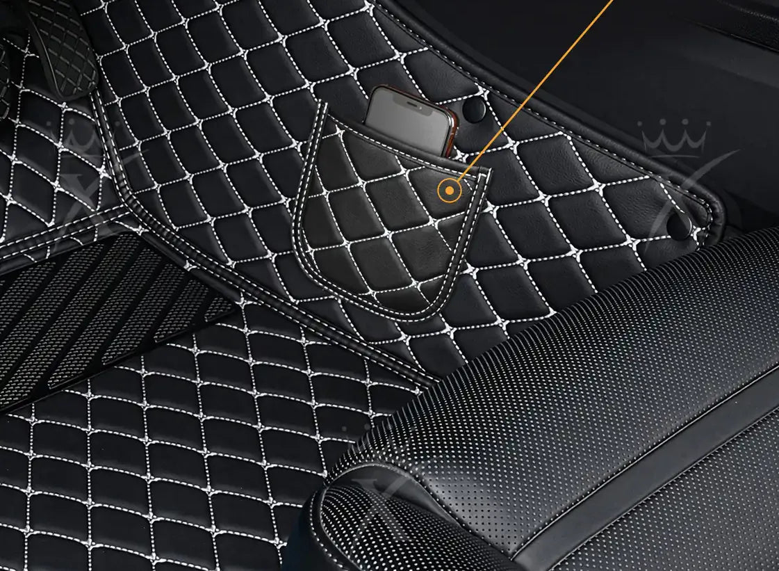 Side storage pocket holding a smartphone on a black diamond stitched car mat